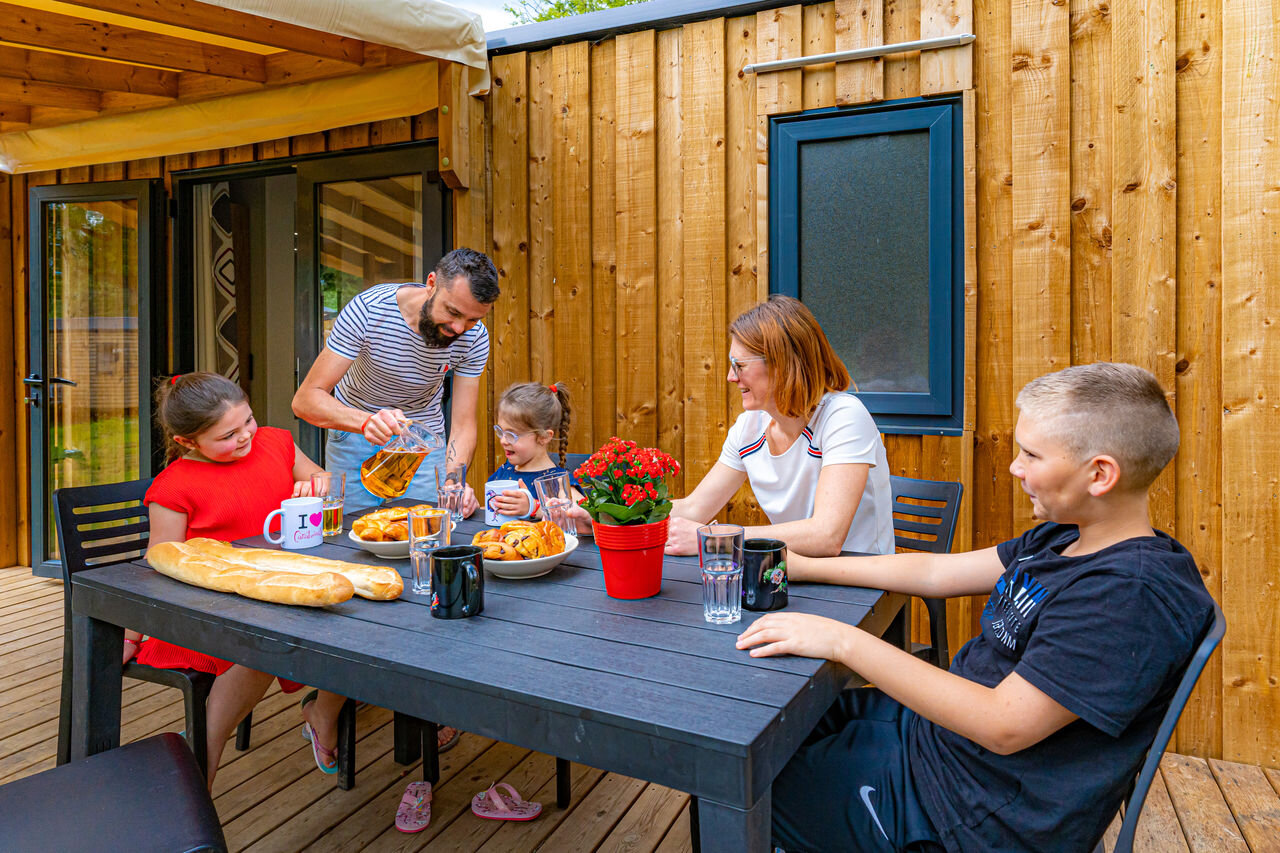 Famille d�jeunant sur la terrasse d'un mobil-home, au camping CAPFUN Aube � Deltebre, Tarragone.