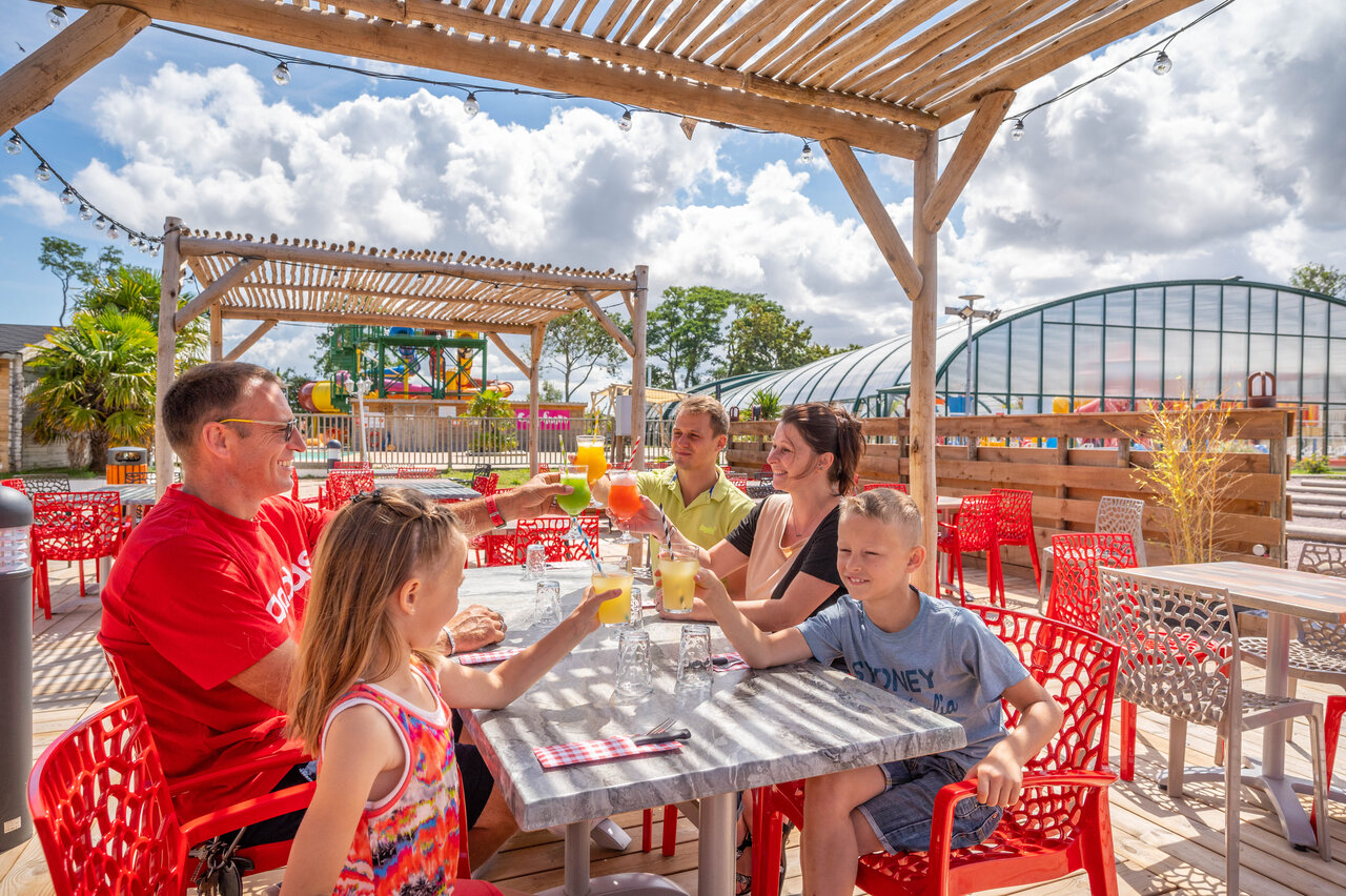 Famille au bar ext�rieur, boissons, piscine, au camping CAPFUN Citadelle de Loustic � Hermanville sur Mer (14).