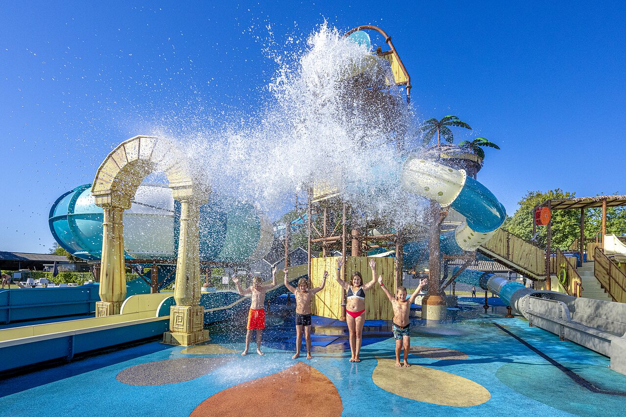 Enfants sous seau d�verseur g�ant au parc aquatique CAPFUN De Belten Rheeze.