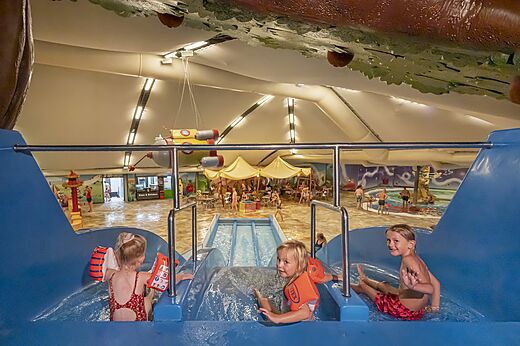 Enfants sur toboggan aquatique int�rieur et piscine au camping CAPFUN De Bongerd � Tuitjenhorn.