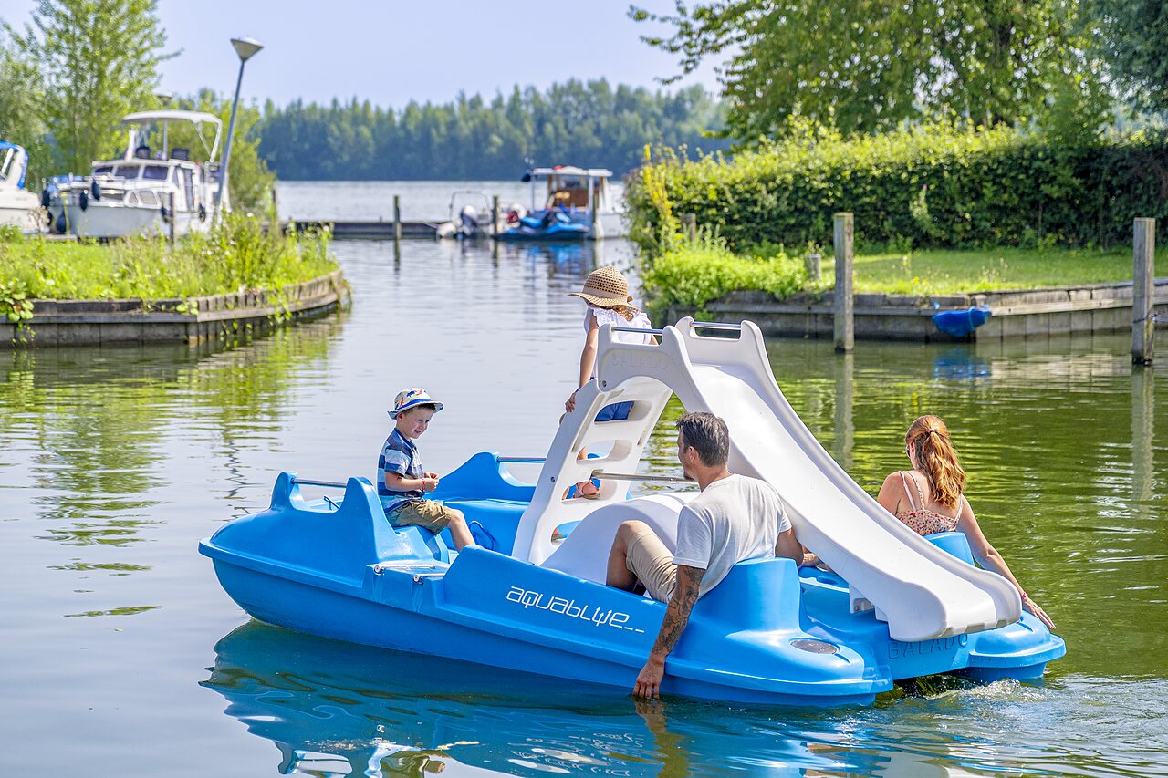 Famille sur p�dalo avec toboggan aquatique au camping CAPFUN Erkemederstrand � Zeewolde.