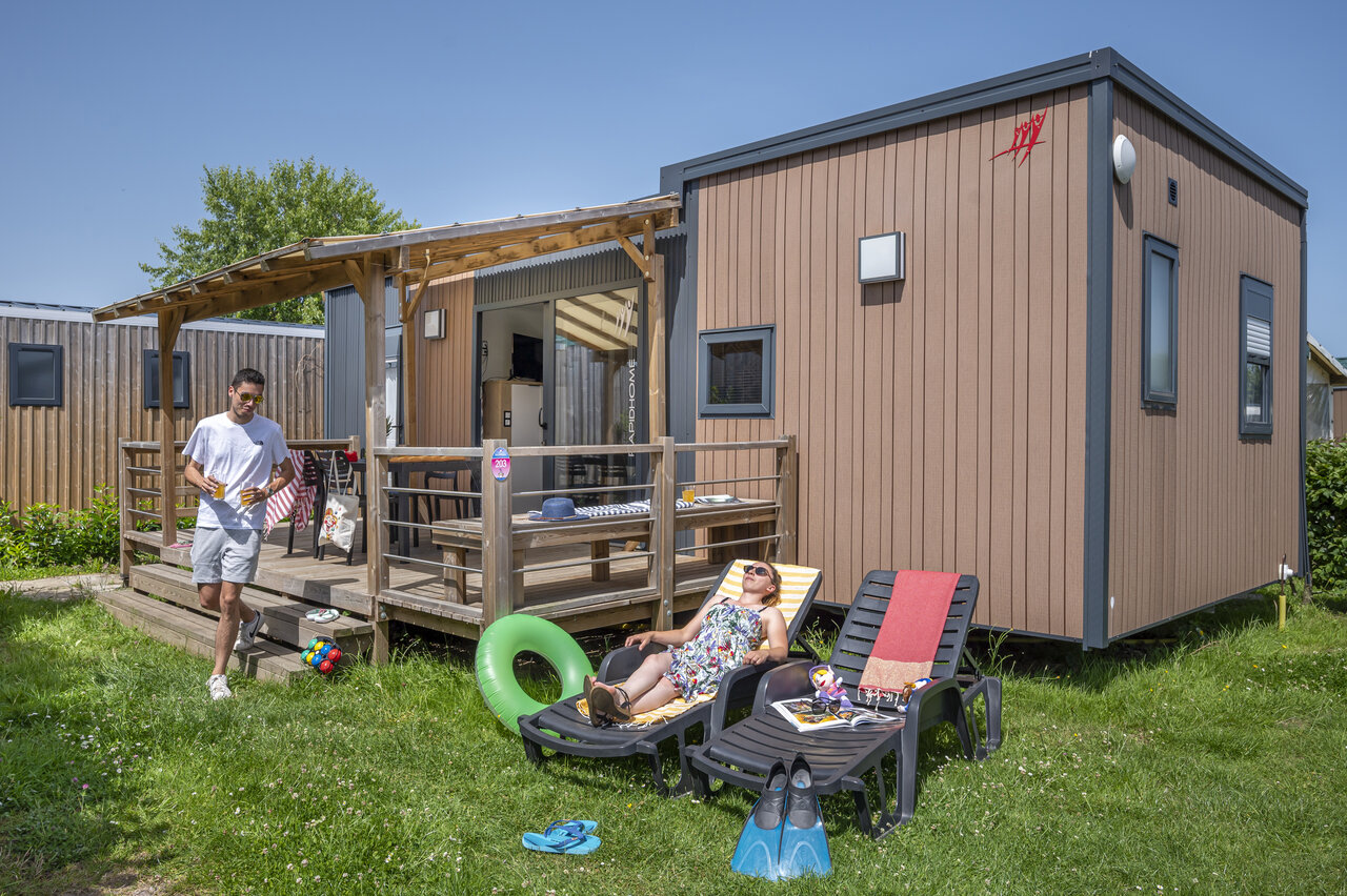 Mobil-home moderne avec terrasse, couple se relaxant au camping CAPFUN Falaises � Gonneville sur Mer (14).