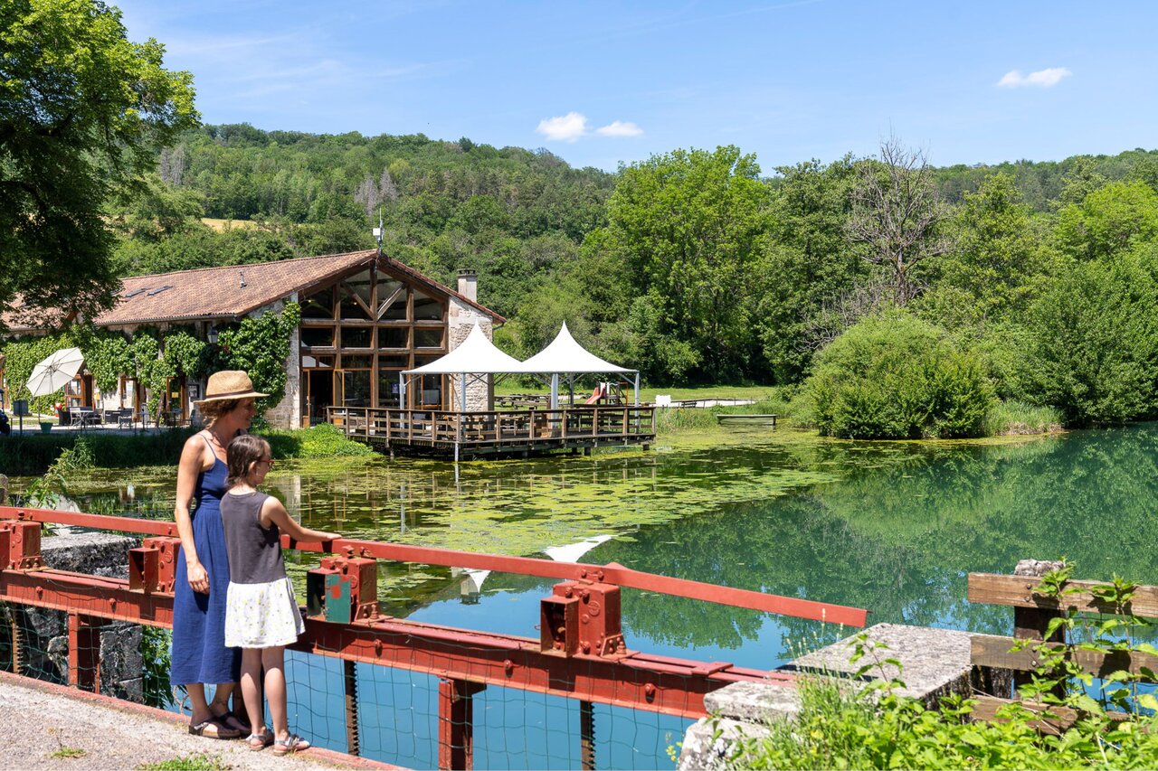Restaurant avec terrasse sur l'eau, verdure au camping CLICOCHIC Forge Sainte Marie.