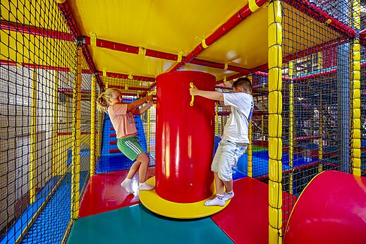 Aire de jeux intérieure colorée avec enfants au camping CAPFUN IJsselstrand à Doesburg.