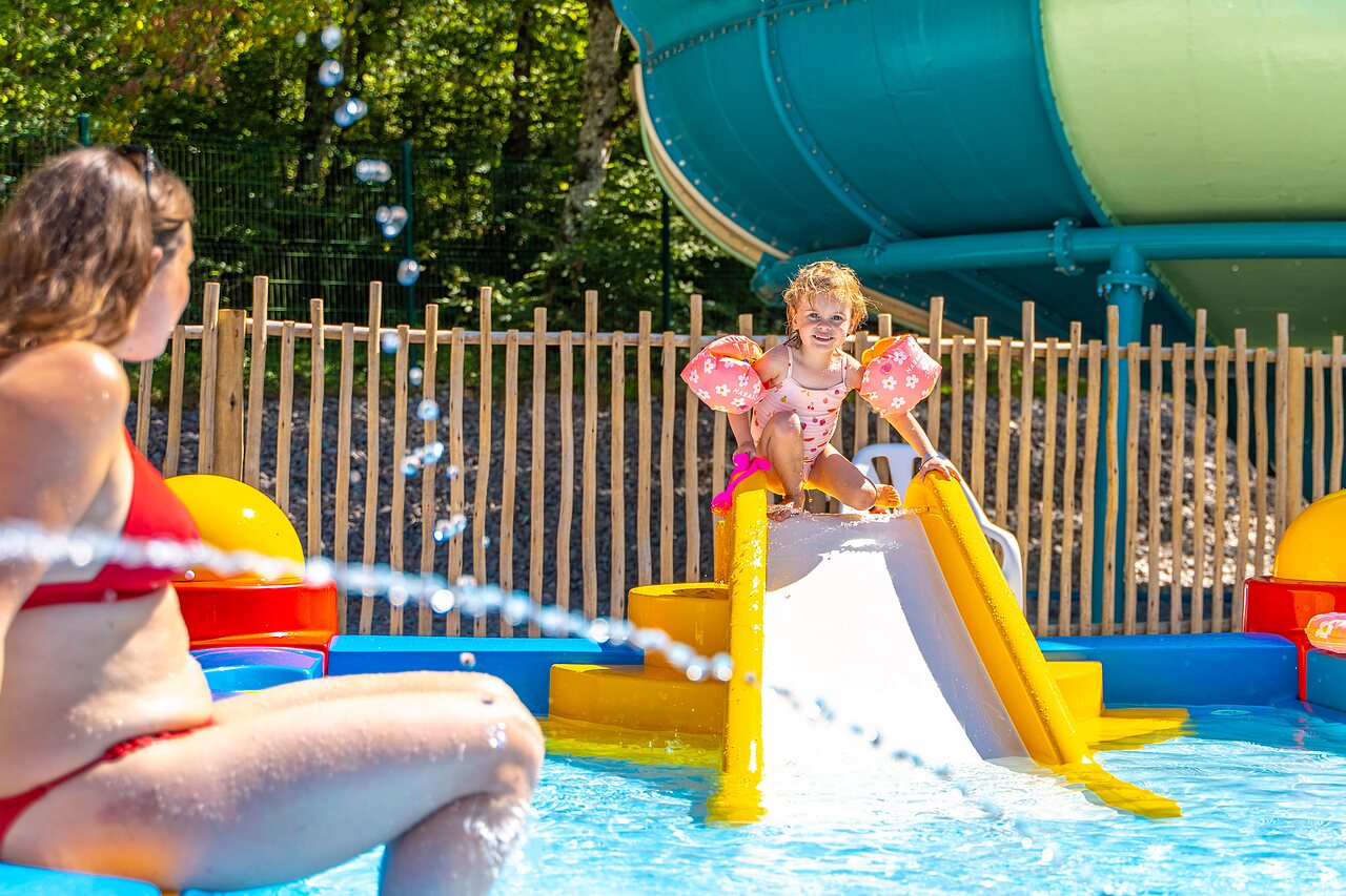 Petite fille sur toboggan aquatique dans la pataugeoire au camping VAGUES OCEANES Lac de Panthier � Vandenesse-en-Auxois (21).