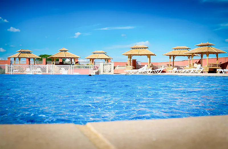 Piscine ext�rieure, pergolas et chaises au camping VAGUES OCEANES Manoir de Balkos Valras-Plage.