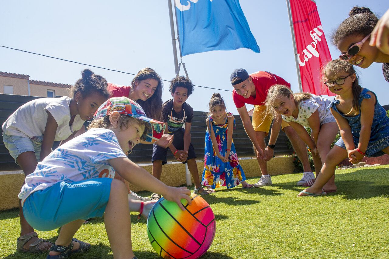 Animation enfants joyeux avec animateurs et ballon au camping VAGUES OCEANES Marinette.