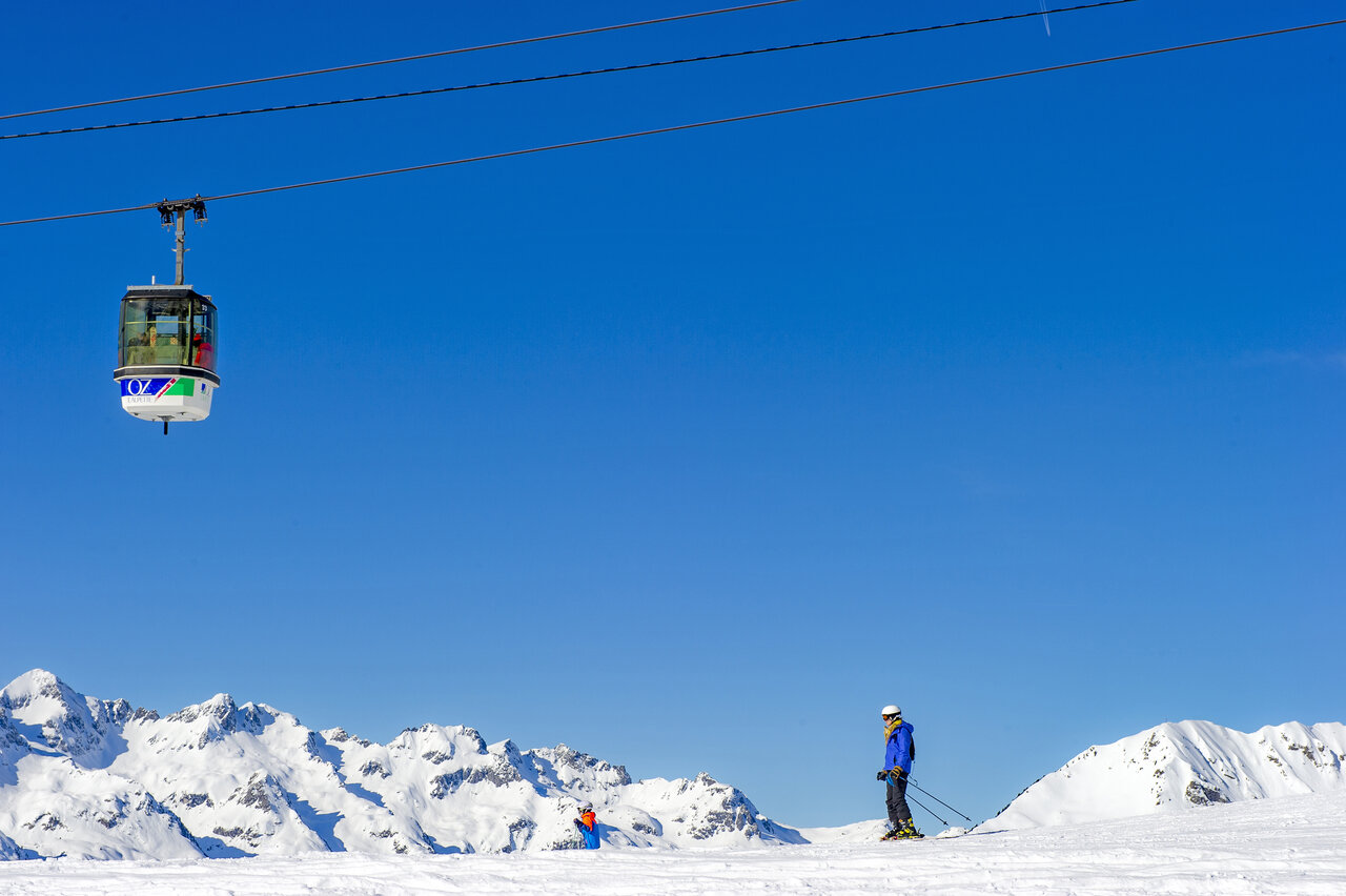Station de ski d'Oz en Oisans, t�l�cabine et skieurs sur pistes enneig�es, Is�re.