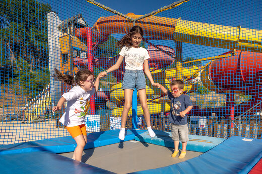 Enfants sur trampoline, toboggans aquatiques au camping CAPFUN Pachacaid à La Mole (83).