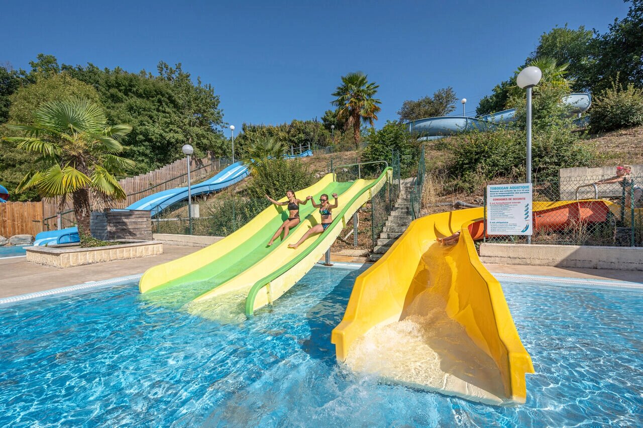 Toboggans aquatiques color�s et piscine ext�rieure au camping CAPFUN La Rivi�re � Valence-en-Poitou.