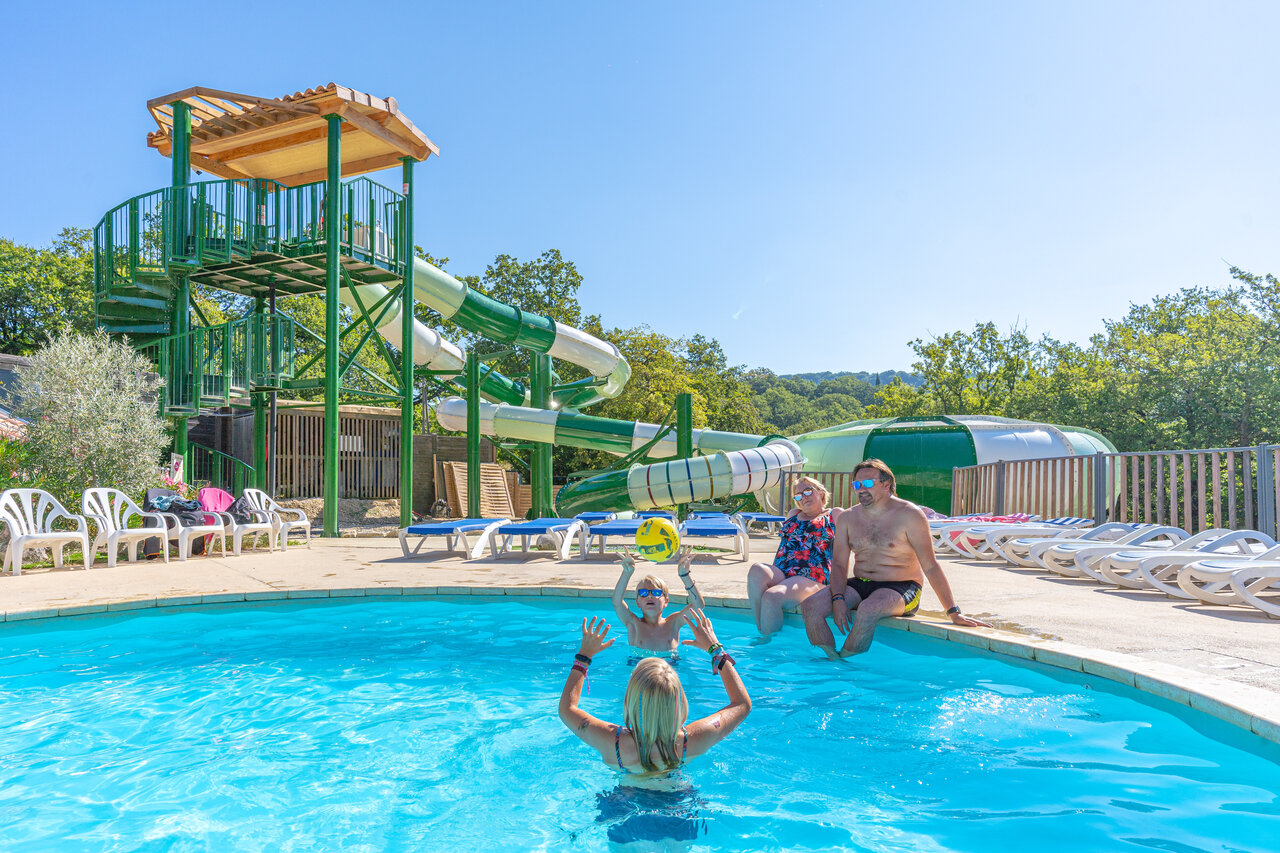 Famille jouant dans la piscine avec toboggans g�ants au camping CLICOCHIC Source du Jabron � Comps (26).
