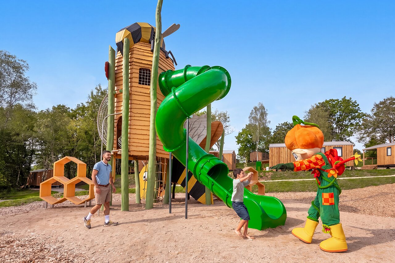 Aire de jeux avec toboggan, enfant et mascotte au camping CLICOCHIC Trelachaume (39).